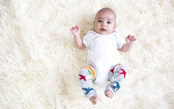 a baby wearing colorful leggings