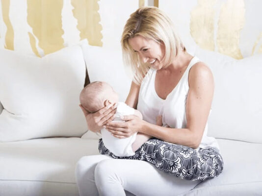 a mom using a nursing pillow