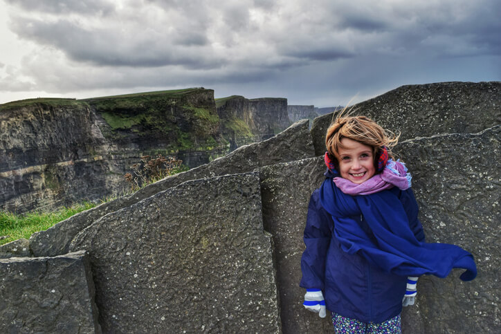 a young Irish girl posing in front of some stunning scenery