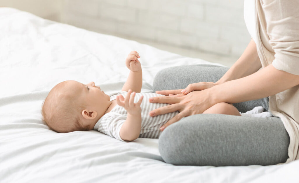 a mom massaging her baby's tummy