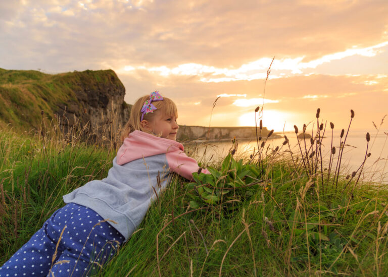 a girl lying in the Irish countryside