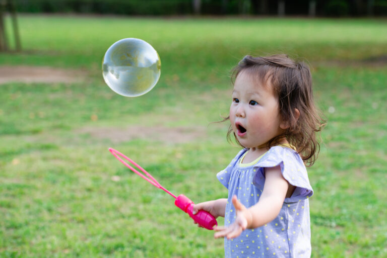 a cute Japanese girl playing in a park