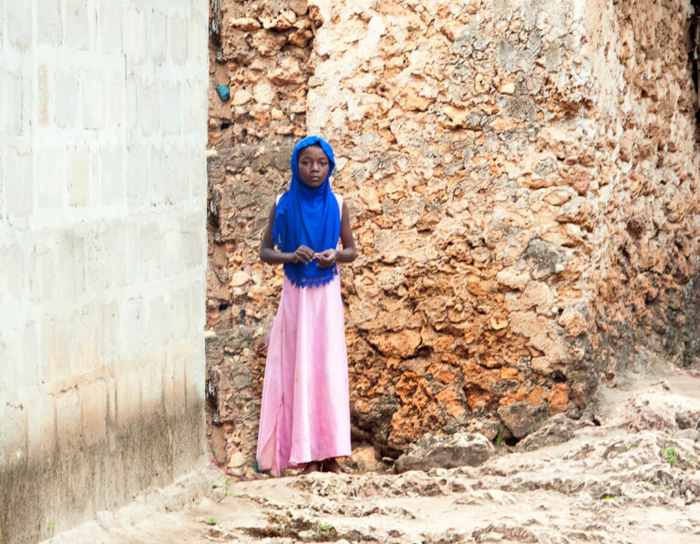 African girl rest on the street in Stone Town on the island of Zanzibar, Tanzania