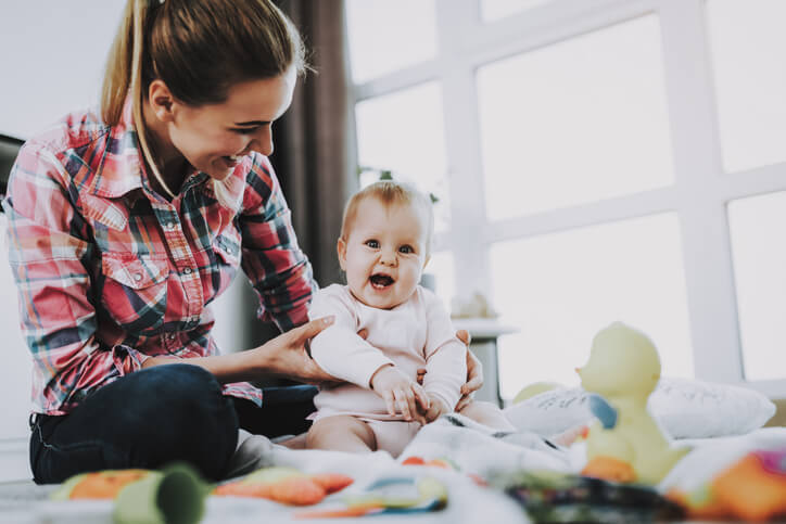 a nanny playing with a young toddler