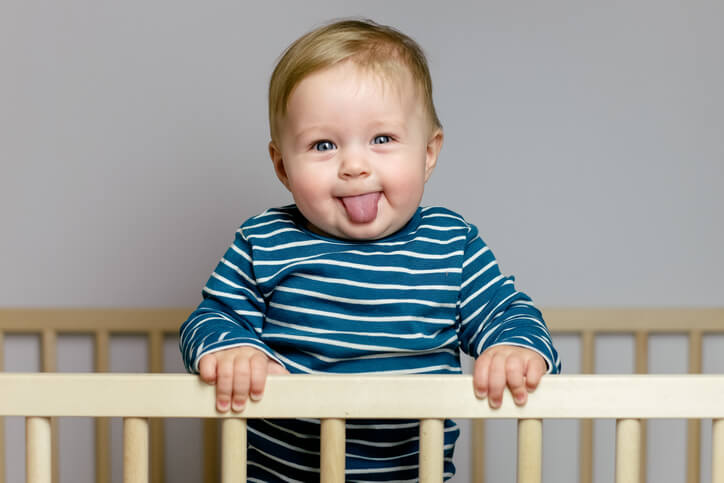 Baby boy playing in the crib