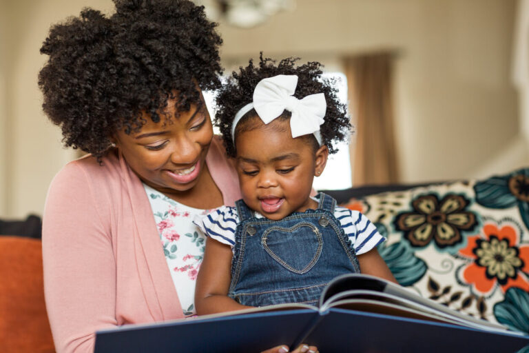 Mother reading a book to her little girl