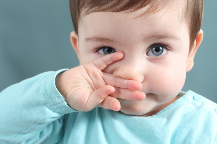 Close up of baby looking at camera with blue eyes