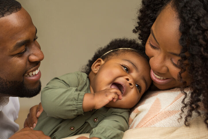 Happy African American family with their little girl