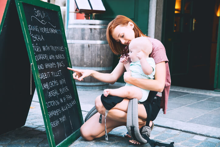 Beautiful young mother with baby child spend time in the old town of Ljubljana