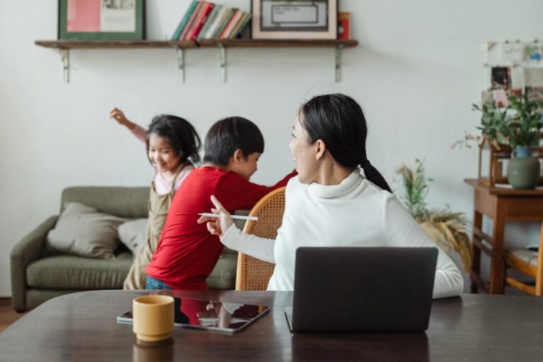 a mom trying to work at home with kids distracting her