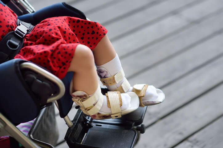 a young girl sitting in a stroller