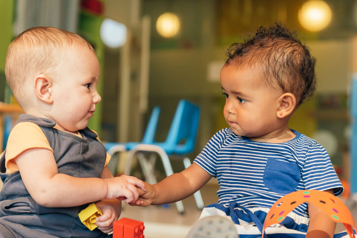 two babies playing together