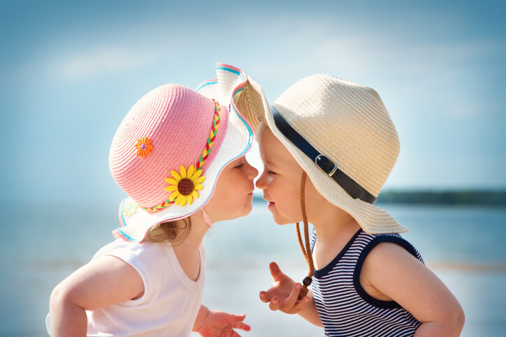 cute baby girl and baby boy touching noses