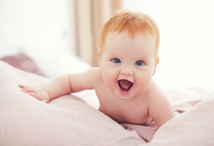 a cute baby girl smiling at the camera