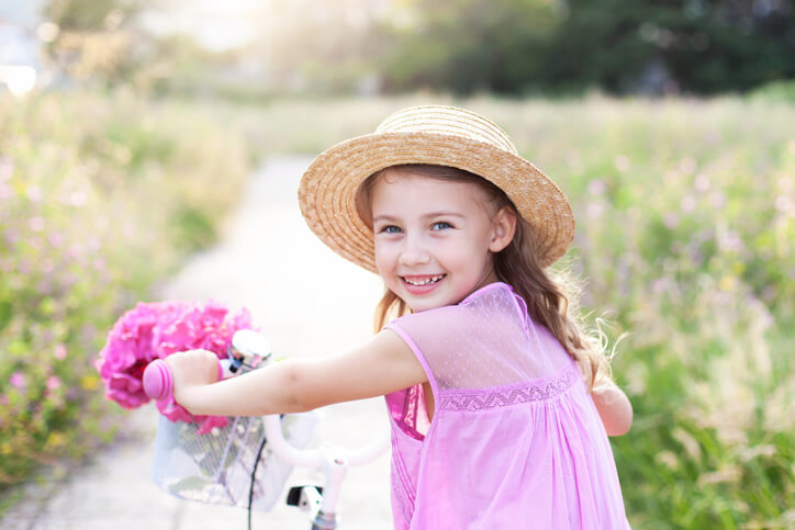 a French girl riding her bike in the countryside