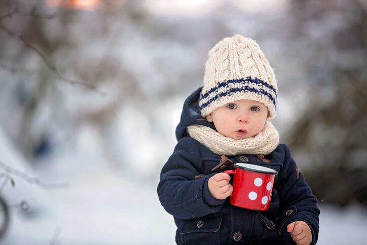 children having winter party in snowy forest