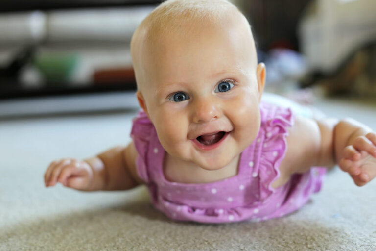 Happy 5 Month old Baby Girl Learning to Crawl