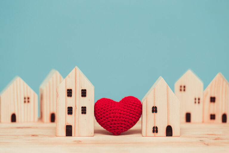 Love heart between two house wood model for stay at home for healthy community together concept