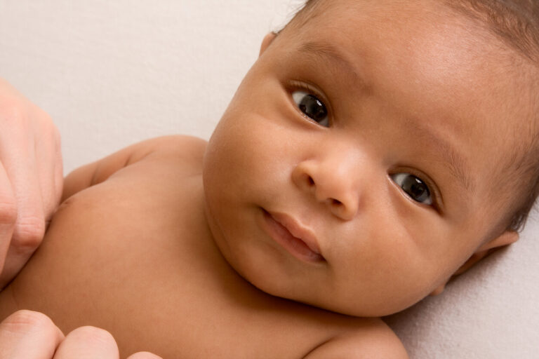 Two months old ethnic baby boy lying down