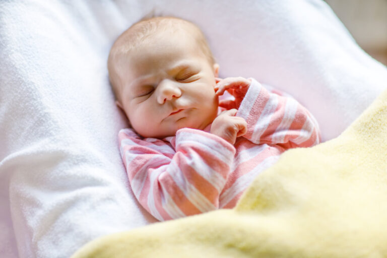 Portrait of cute adorable newborn baby girl sleeping